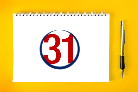 End of the month, Paper Calendar Page with Spiral Binding with pencil stroke around the last day of the month.の写真素材