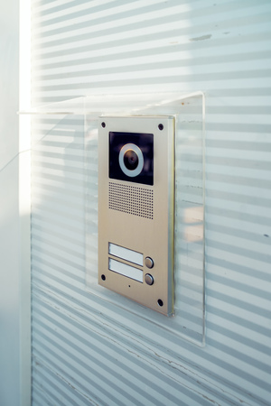 Video intercom device on building exterior wall for house entry and communicationの写真素材