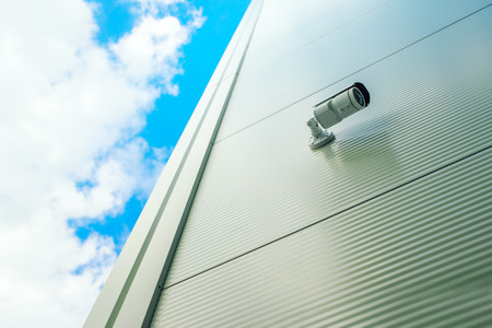 Security surveillance camera on shopping mall exterior wall