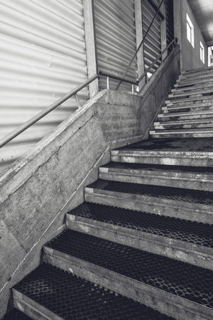Industrial warehouse concrete staircase, black and white monochromatic wide angle lens imageの写真素材