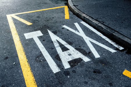Taxi station and parking space on the street, sign painted on asphalt roadの写真素材