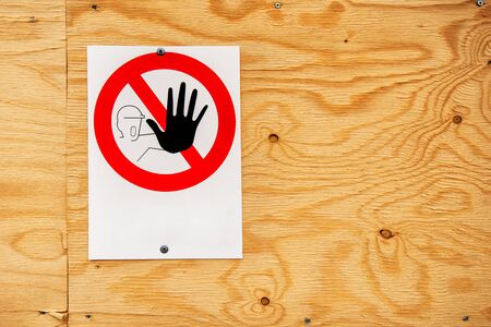 No pass warning sign on construction site attached to plywood board backgroundの写真素材
