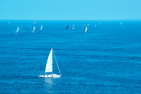 White yachts sailing at sea, idyllic summertime sceneryの写真素材