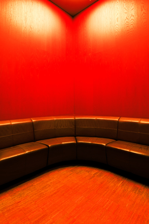 Modern waiting room interior with empty leather seats and hardwood flooringの写真素材