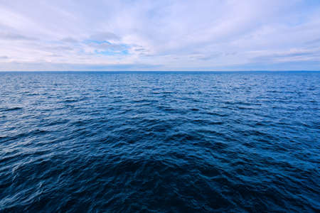 Blue seascape background, wide angle view of the sea surface on cold winter dayの写真素材