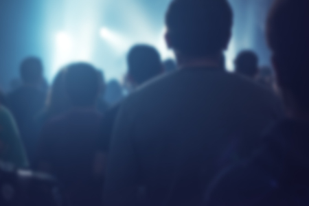 Blur defocused concert crowd as abstract background, people at popular rock music live performance