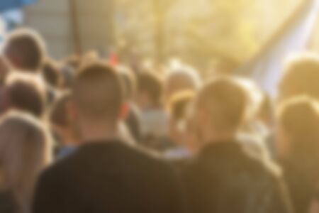 Large group of unrecognizable people as audience to politician's speech outdoors, defocused crowd attending political meetingの写真素材