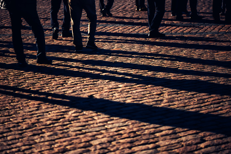 Crowd, group of people on the street, pedestrians walking on public location, general public concept for community and population themes, selective focusの写真素材