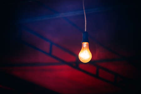 Old light bulb glowing in the darkの写真素材