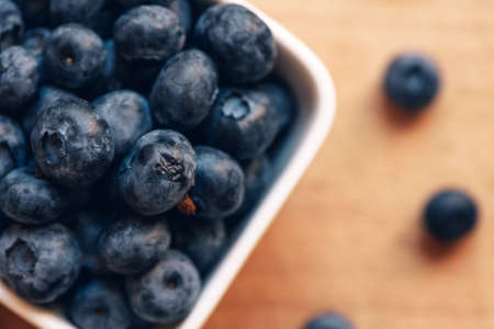 Blueberries in ceramic bowl, fresh berry fruit, selective focusの写真素材