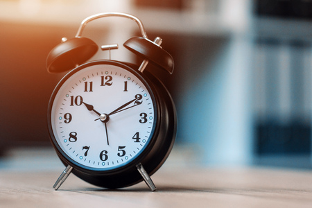 Vintage clock on business office table, selective focus
