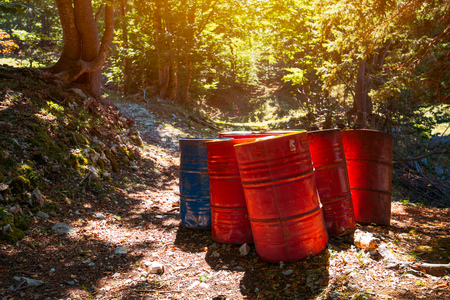 Toxic waste barrels in the forest, environmental issue and ecologyの写真素材