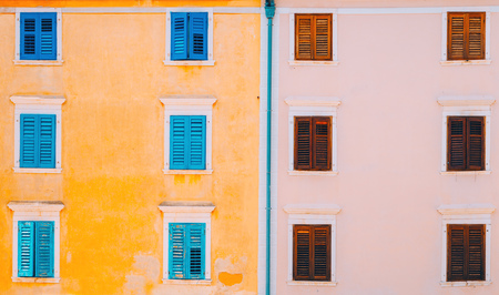 Typical mediterranean facade architecture style with wooden shutter blinds on windowsの写真素材