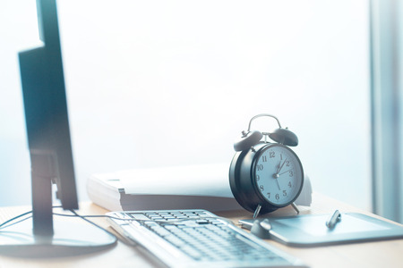 Business project deadline, vintage clock on office desk, selective focusの写真素材