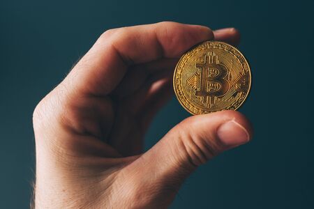 Bitcoin cryptocurrency in hand, blockchain technology decentralized currency coinの写真素材