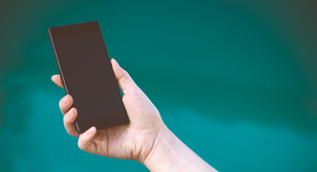 Female hand with new modern mobile phoneの写真素材