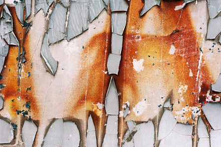 Abstract scratched texture of torn paper glued to a rusty metal surface as background の写真素材