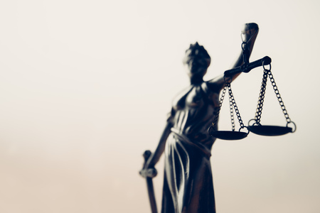 Statue of lady Justice or Justitia with scale on bright backgroundの写真素材
