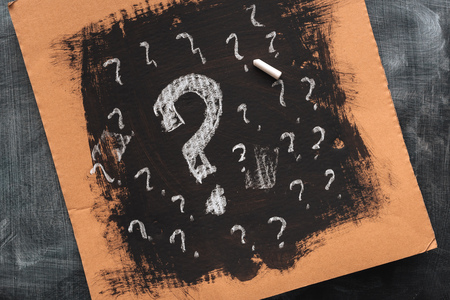 Sketched question marks on cardboard paper, concept of perplex and confusionの写真素材
