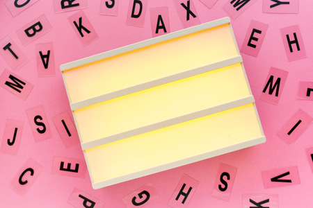 Blank lightbox and letters on girly pink background, mock up copy space for text