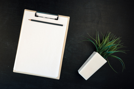 Notes clipboard with pencil and blank sheets of paper as mock up copy space, top view