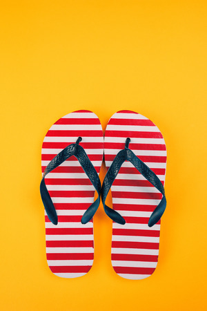 Stylish flip flop sandals with USA flag pattern, top view with copy space over yellow backgroundの写真素材