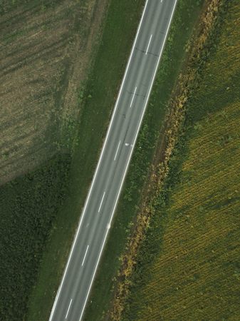Drone photography of empty road through plain countryside landscape, aerial view of two lane roadway...