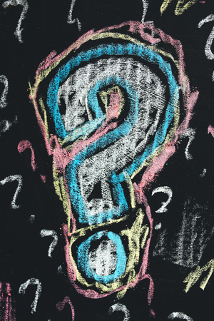 Sketched colorful question mark on cardboard paper, concept of perplex and confusionの写真素材