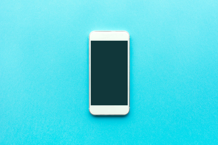 Smartphone with blank mock up screen, top view minimalistic composition