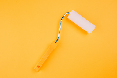 Paint roller for wall painting in vivid warm colorsの写真素材