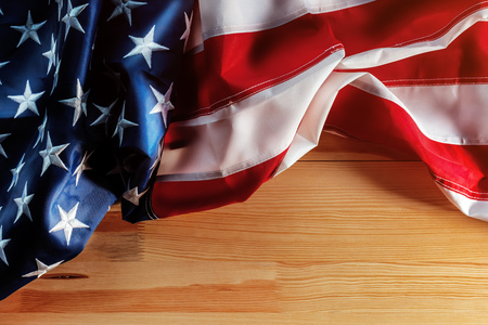United States Flag day concept with american flag crumpled on wooden background with copy space