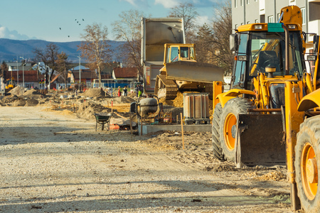 Construction vehicle with loader on building site, industrial heavy machineryの写真素材