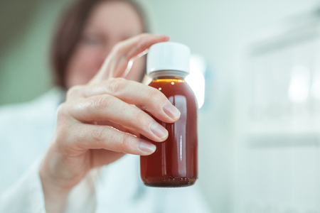 Pediatrician recommends paracetamol syrup for medical treatment of baby patients in pediatrics medical office, selective focusの写真素材