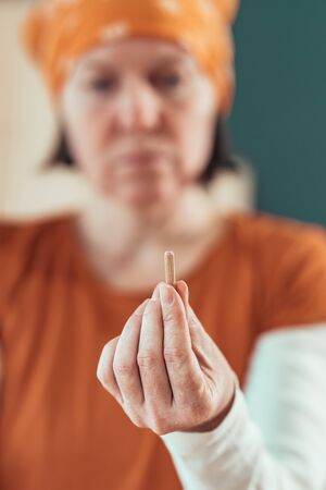 Female carpenter working with wooden dowels in carpentry woodwork workshop, selective focus