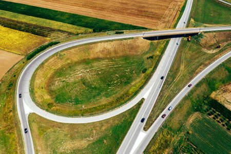 Aerial view of road interchange from drone pov in summer afternoonの写真素材
