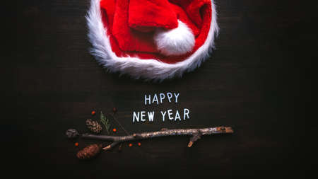Happy New Year text with Santa Claus hat, flat lay top viewの写真素材