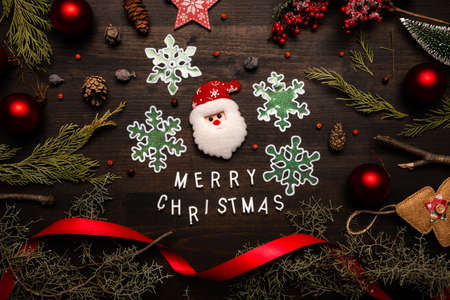 Merry Christmas message flat lay top view with Santa Claus, snowflakes and various Xmas ornamentsの写真素材