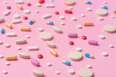 Variety of pills and tablets medicine for female health and femtech concept background, selective focusの写真素材