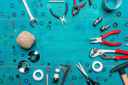 Plumbing toolkit on work desk top view flat lay, water pump wide jaw pliers and other toolsの写真素材