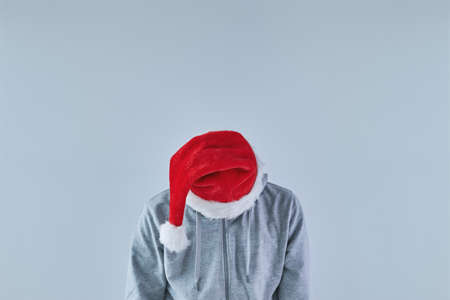 Depressed and sad man with Santa Claus hat looking down, image with copy spaceの写真素材