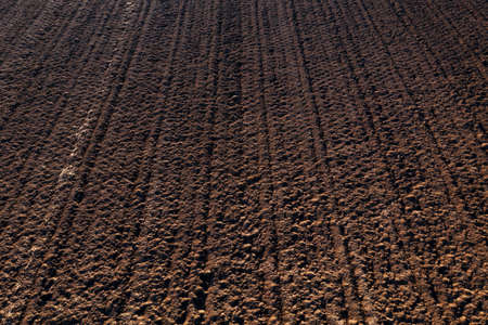 Aerial view of plowed and irrigated farm land ready for sowing of the crops as agricultural backgroundの写真素材
