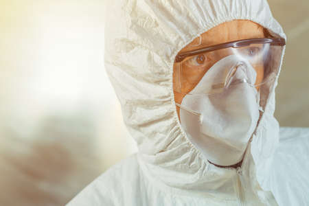 Perturbed medical worker in protective clothing in hospital quarantineの写真素材