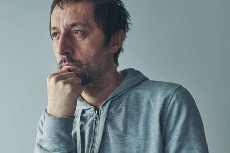 Introspection concept, man thinking an analyzing himself, portrait of thoughtful casual caucasian...