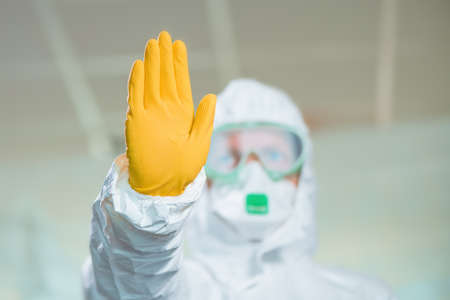 Female epidemiologist gesturing stop sign in hospital quarantine, selective focusの写真素材