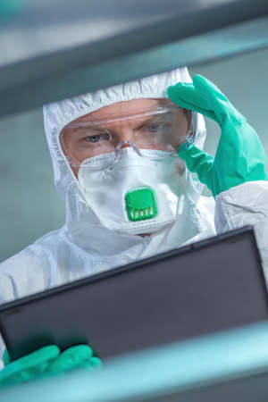 Virologist healthcare professional using tablet computer in laboratory, close up of medical worker...