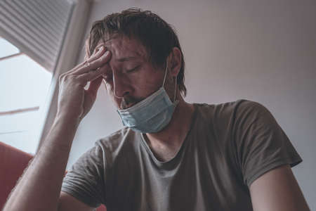 Worried stressed man self-isolated in home quarantine during covid-19 coronavirus pandemic,...