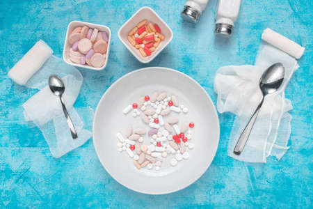 Medical overuse top view flat lay concept with plate full of various drugsの写真素材