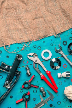 Plumbing toolkit on work desk top view flat lay, water pump wide jaw pliers and other toolsの写真素材