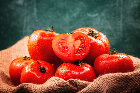 Pile of fresh ripe organic tomato sprayed with water