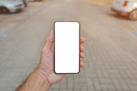 E-parking app for smartphone mock up, mobile phone in male hand